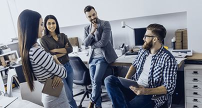 Group of professionals discussing ideas in a modern office setting.